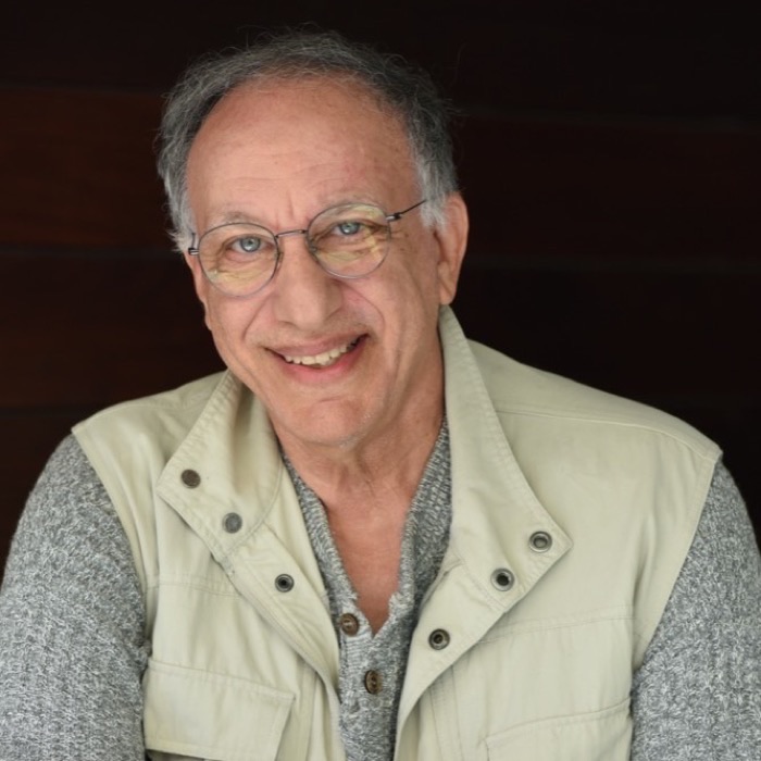 Weird Tales filmmaker Ted Faye, smiling in round glasses and a canvas field vest